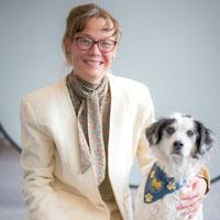 Portrait photo of Kimberly Crystal Monroe with her therapy dog, Caledonia.